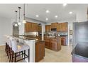 Spacious kitchen features dark cabinetry, granite countertops, with a breakfast bar, blending style and functionality at 4631 Cypress Forest Ln, St Cloud, FL 34772