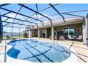 Sparkling screened-in pool, perfect for outdoor relaxation and entertainment, surrounded by ample patio space at 4631 Cypress Forest Ln, St Cloud, FL 34772