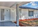 Inviting front porch featuring a stylish entry door and manicured flowerbeds at 5307 Sandy Hill Dr, Orlando, FL 32821