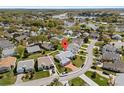 Aerial view of a home situated on a cul-de-sac, boasting mature landscaping and a three-car garage at 5414 Zinnia St, Leesburg, FL 34748