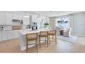 Bright eat-in kitchen features an island with seating, and stainless steel appliances at 6033 Tree Crossing Ln, St Cloud, FL 34771