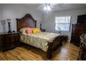 Comfortable bedroom with decorative wood trim bed frame and wood laminate flooring at 613 Andrew St, Altamonte Springs, FL 32714