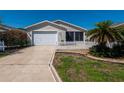Charming one story home featuring attached one car garage and screened in porch, surrounded by a white picket fence at 790 Blake Ln, The Villages, FL 32162