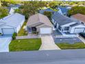 An aerial view of the single story home, with well maintained lawns, and a street view of a quiet neighborhood at 8201 Se 169Th Palownia Loop, The Villages, FL 32162