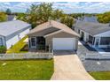 Charming single story home featuring an attached garage, well maintained front lawn, and a cozy screened in porch at 8201 Se 169Th Palownia Loop, The Villages, FL 32162