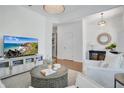 Inviting living room with stylish decor, hardwood flooring, a television and light-filled space at 8549 Lovett Ave, Orlando, FL 32832