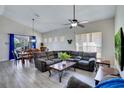 Spacious living room area featuring vaulted ceilings and a comfortable sectional sofa with a view to the dining area at 1019 Tuscan Hills Blvd, Davenport, FL 33897