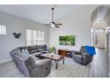 Bright living area with gray plank flooring and sectional sofa with large window and ceiling fan at 1019 Tuscan Hills Blvd, Davenport, FL 33897