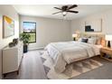 Comfortable bedroom with plush carpeting, a large window, and neutral decor at 1172 Moyle Way, Mascotte, FL 34753