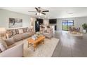 Inviting living room with neutral tones, modern furnishings, and an open floor plan to the kitchen and dining area at 1172 Moyle Way, Mascotte, FL 34753