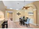 Dining room with tile flooring, modern light fixture, and convenient bar seating area at 134 Woodleaf Dr, Winter Springs, FL 32708