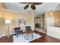 Inviting living room featuring hardwood floors, a ceiling fan, and views into the dining room at 134 Woodleaf Dr, Winter Springs, FL 32708