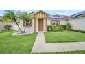 Inviting single-story home with lush landscaping, a walkway to the front door, and solar panels at 14815 Tullamore Loop, Winter Garden, FL 34787