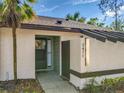 The main entrance to the property displays a secure storm door and updated paint at 2471 Tahoe Cir # 00, Winter Park, FL 32792