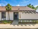 Charming front facade featuring neutral stucco, modern pergola, and manicured landscaping at 2471 Tahoe Cir # 00, Winter Park, FL 32792