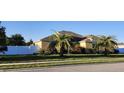 Inviting single-story home with stucco siding, palm trees, and manicured lawn at 2749 Sand Oak Loop, Apopka, FL 32712