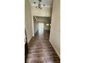 Open foyer showcasing wood-look tile flooring, high ceilings, and a view into the spacious living areas at 2749 Sand Oak Loop, Apopka, FL 32712
