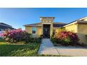 Charming single-story home with a covered entryway and beautifully landscaped garden at 2749 Sand Oak Loop, Apopka, FL 32712