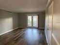 Bright living room featuring hardwood flooring, neutral walls, closet and sliding doors to a patio at 395 Wymore Rd # 200, Altamonte Springs, FL 32714