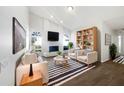 Bright living room featuring a white brick fireplace, modern furnishings, and large windows at 3951 Haynes Cir, Casselberry, FL 32707