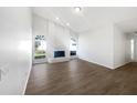 Open living room featuring wood flooring, a decorative fireplace, and lots of natural light at 3951 Haynes Cir, Casselberry, FL 32707