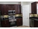 Kitchen featuring stainless steel appliances and backsplash lighting at 4964 Luge Ln, Orlando, FL 32839