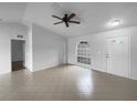 Spacious living room with tiled floors, neutral tones, and a ceiling fan at 546 Koala Dr, Kissimmee, FL 34759