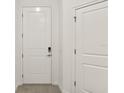 Clean and bright entryway featuring a white door with smart lock at 10359 Ebb Tide Ln, Orlando, FL 32821