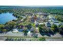 Aerial view of the property, showing its location near a lake and surrounded by trees at 120 Lake Dr, Oviedo, FL 32765