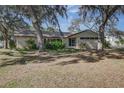 Cozy single-story home with stone accents and mature trees shading the front yard at 120 Lake Dr, Oviedo, FL 32765