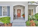 Inviting covered front porch with seating, beautiful landscaping and views of the neighborhood at 1582 Almond Ave, Orlando, FL 32814