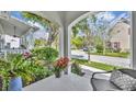 Cozy front porch view showcasing seating and lush landscaping at 1582 Almond Ave, Orlando, FL 32814