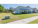 View of the front of a beautiful home with lush green lawn and side yard in a quiet neighborhood at 16805 Sunrise Vista Dr, Clermont, FL 34714