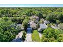 An aerial view of a well-maintained home surrounded by lush trees and greenery in a serene neighborhood at 2006 E Harding St, Orlando, FL 32806