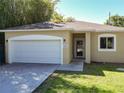 Inviting home with a two-car garage, well-kept lawn, and a welcoming front entrance at 2006 E Harding St, Orlando, FL 32806