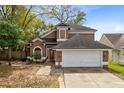 Charming two-story home with a well-maintained lawn and inviting entryway at 217 Oak Park Pl, Casselberry, FL 32707