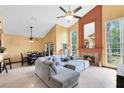 Spacious living room with high ceilings, fireplace, and a comfortable gray sectional sofa at 217 Oak Park Pl, Casselberry, FL 32707