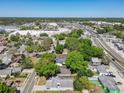 A residential neighborhood with lush green trees, commercial area and a busy road in the background at 2253 Atrium Cir, Orlando, FL 32808