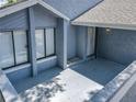Inviting front porch with gray flooring and a white door at 2253 Atrium Cir, Orlando, FL 32808