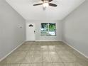 Spacious living area with tile floors, large window, and ample natural light at 233 Chadworth Dr, Kissimmee, FL 34758