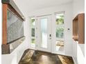 Bright, modern foyer with a unique water feature and stylish frosted glass front door and sidelights at 2411 Center Ave, Orlando, FL 32806