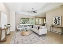 Bright living room features neutral colors, a ceiling fan, and sliding glass doors to the lanai at 2480 Northumbria Dr, Sanford, FL 32771