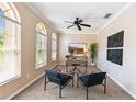 Office featuring two chairs, desk, natural light, and a decorative ceiling fan at 2480 Northumbria Dr, Sanford, FL 32771