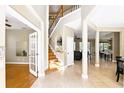 Bright foyer features a beautiful staircase and views into the front office and dining room at 3780 Woodhurst Ct, Oviedo, FL 32766