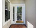 Close-up of the front door featuring decorative glass and a classic black handle at 3960 Villas Green Cir, Longwood, FL 32779