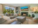 Cozy living room with a stone fireplace, built-in shelving, and large view window at 533 Moree Loop, Winter Springs, FL 32708