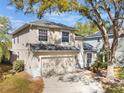 Well-maintained two-story home with a two-car garage and a spacious driveway at 8380 Baywood Vista Dr, Orlando, FL 32810