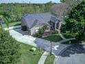 Aerial view of house with a long driveway, beautiful landscaping, and a well maintained lawn at 876 Kensington Gardens Ct, Oviedo, FL 32765