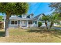 Charming two-story blue home with a well-manicured lawn and inviting front porch at 1019 Spring Landing Dr, Winter Garden, FL 34787