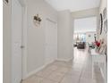Neutral hallway with tile flooring that leads to an open concept living area at 11038 Leafshore Loop, Orlando, FL 32829